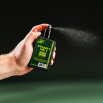 BULLITT No. 1 held mid-spray, mist carrying across a dark green ground